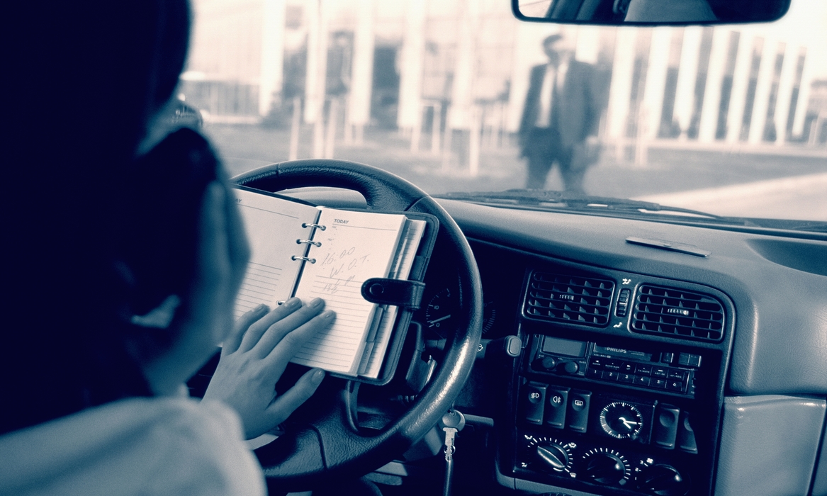 Woman Multitasking While Driving