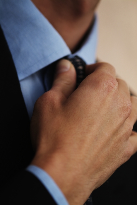 Businessman Adjusting Tie