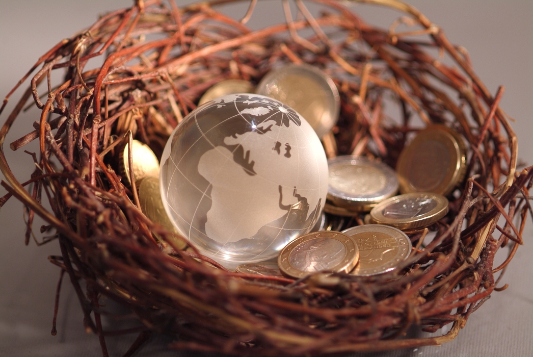 Financial Concept Coins in a Nest with World Globe