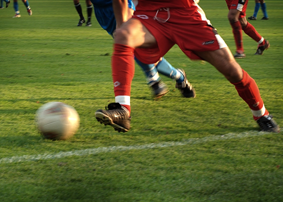 European Football: Soccer Player Kicks the Ball