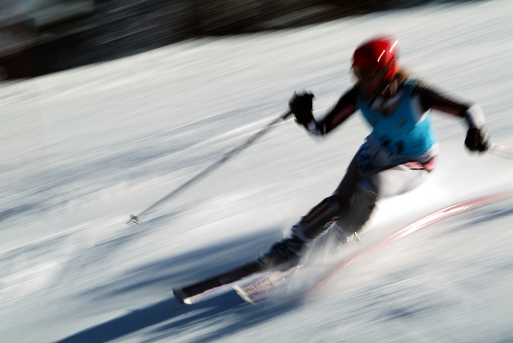 Downhill Skier Navigates a Tight Turn During Race