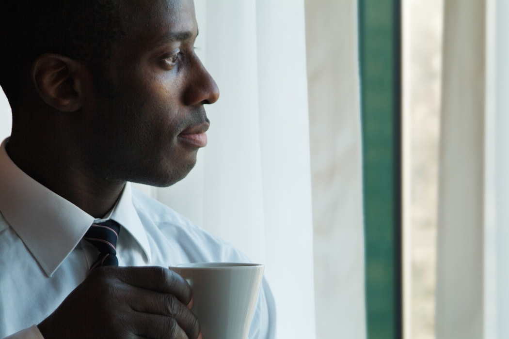 Businessman Having Coffee in Room