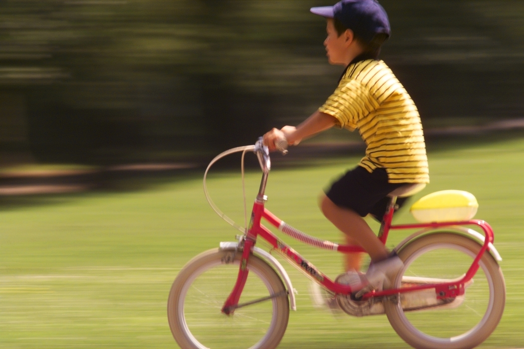 Boy Riding Bike in Park