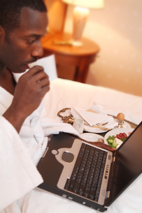 Man Having Breakfast & Working on Computer