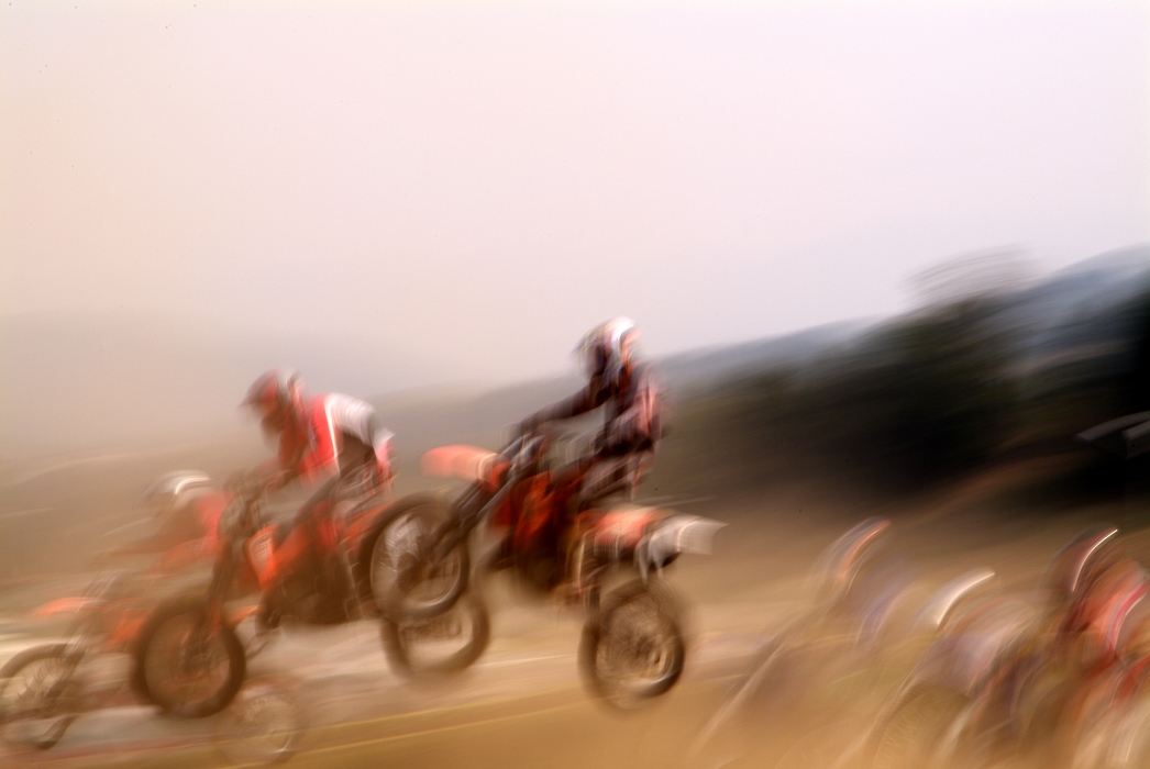 Motocross Racing Racers Make a Jump