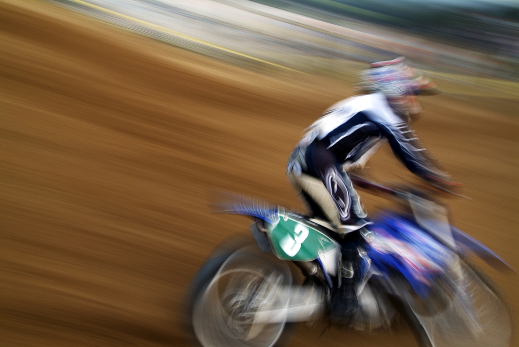 Motocross Racing Single Racer Makes a Turn