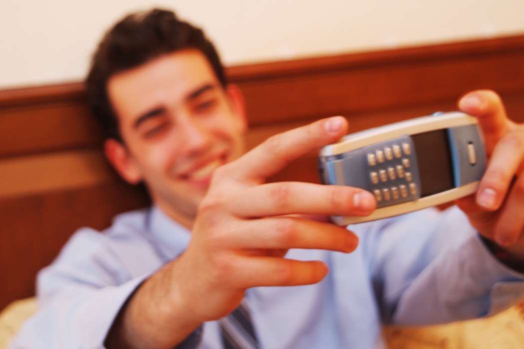 Man Taking a Picture with Cell Phone