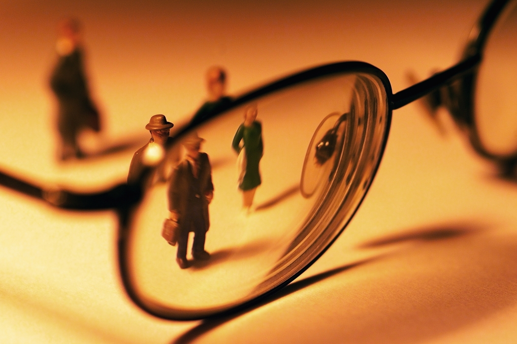 Toy People Looking Through Eyeglasses