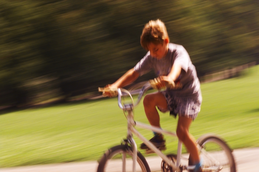 Boy Riding Bike in Park