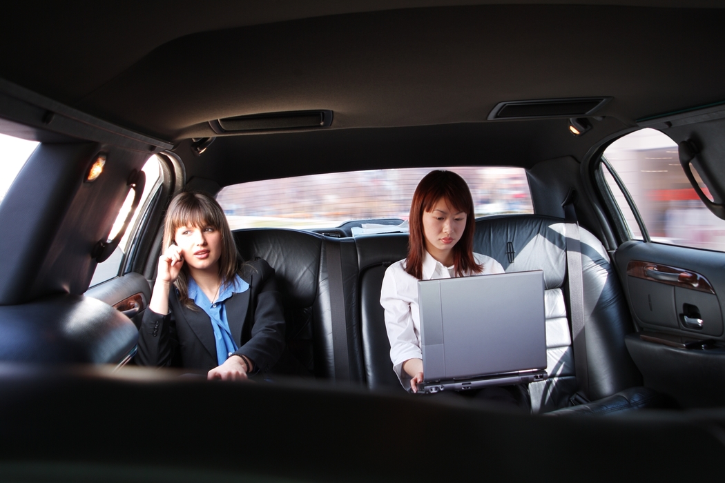 Businesswoman Working in a Limousine